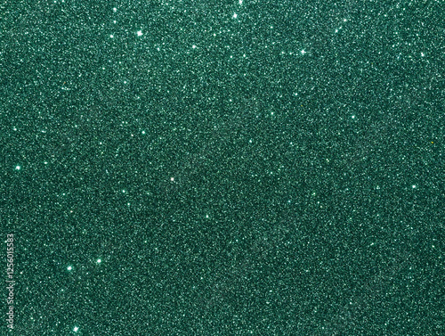 Green sparkle background. Deep green glitter background. Green glimmer. Abstract twinkle texture. Glitter surface. Glimmer layout. Holiday layout. Emerald green luxury surface. Celebration background.
