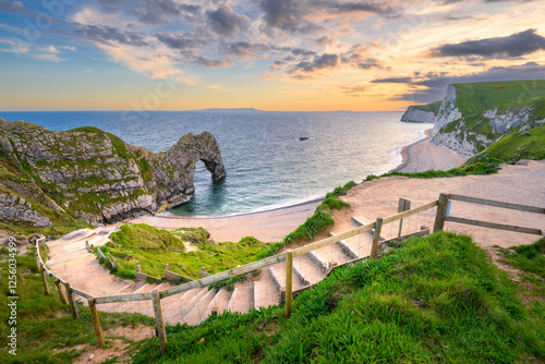 Steps leading down to Durdle Door beach on a summer evening at The Jurassic Coast, Dorset, UK. photo