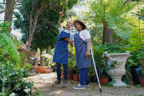 Disabled people working in plant nursery photo