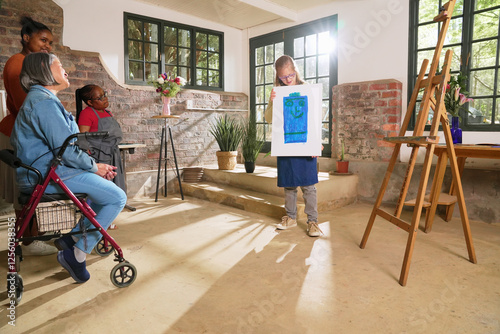 Disabled women looking at painting in art studio photo