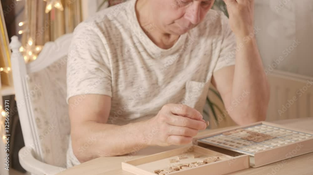 senior man focused on solving sudoku puzzle on wooden board, Brain exercise, cognitive health, and mental agility in mature age, mental stimulation, brain health