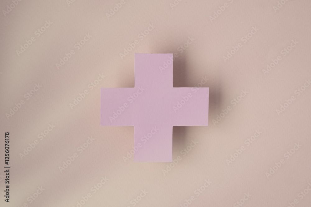 Obraz premium the symbol of the cross on a pink background, symbolizing healthcare and medical services