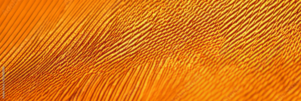 Fototapeta premium Bright amber cotton fabric with diagonal twill weave pattern for creative design projects