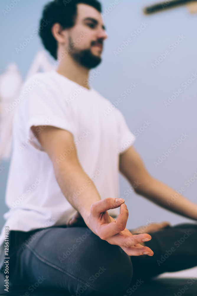 Focused male meditating in Lotus position Focused male meditating in Lotus position
