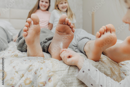Photos children tickle each other's heels with a feather