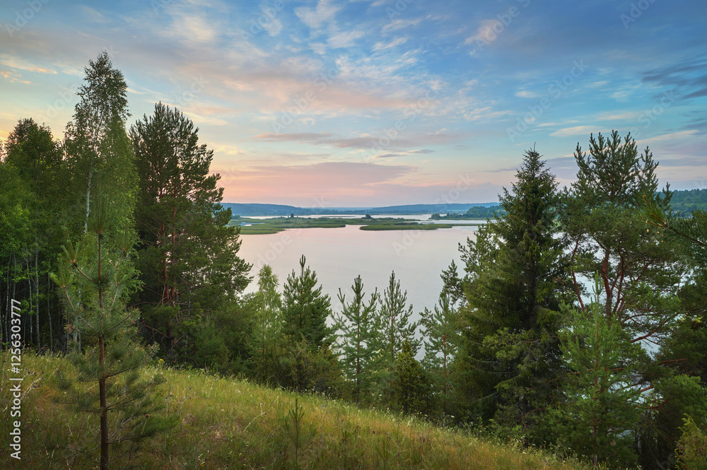 A beautiful morning on the riverbank with a panoramic view of the clouds in the distance. A beautiful morning on the riverbank with a panoramic view of the clouds in the distance.