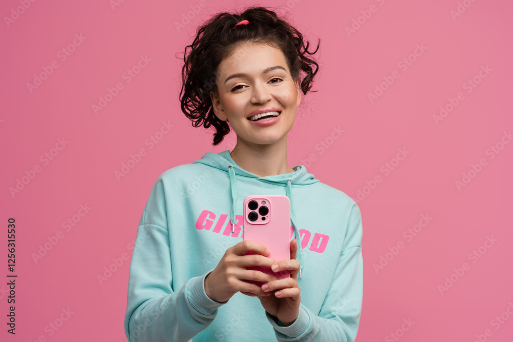 smiling happy beautiful woman in stylish sports outfit posing on pink background isolated in studio smiling happy beautiful woman in stylish sports outfit posing on pink background isolated in studio