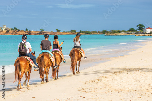 Fototapeta Naklejka Na Ścianę i Meble -  Tourists horseback riding on the beach in Antigua and Barbuda.
