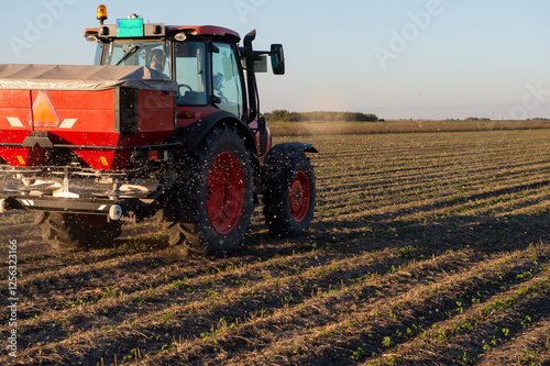 Tractor spreading artificial fertilizers
