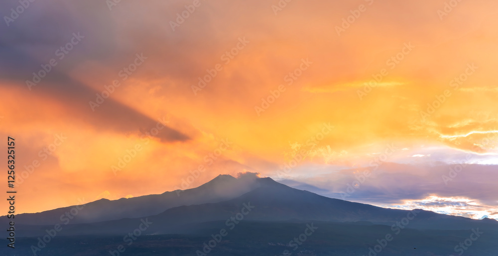 beautiful panorama of volcano mountain during evening synset with twilight clouds and shadows above majectic mountain and amazing cloudy sunset sky on background beautiful panorama of volcano mountain during evening synset with twilight clouds and shadows above majectic mountain and amazing cloudy sunset sky on background