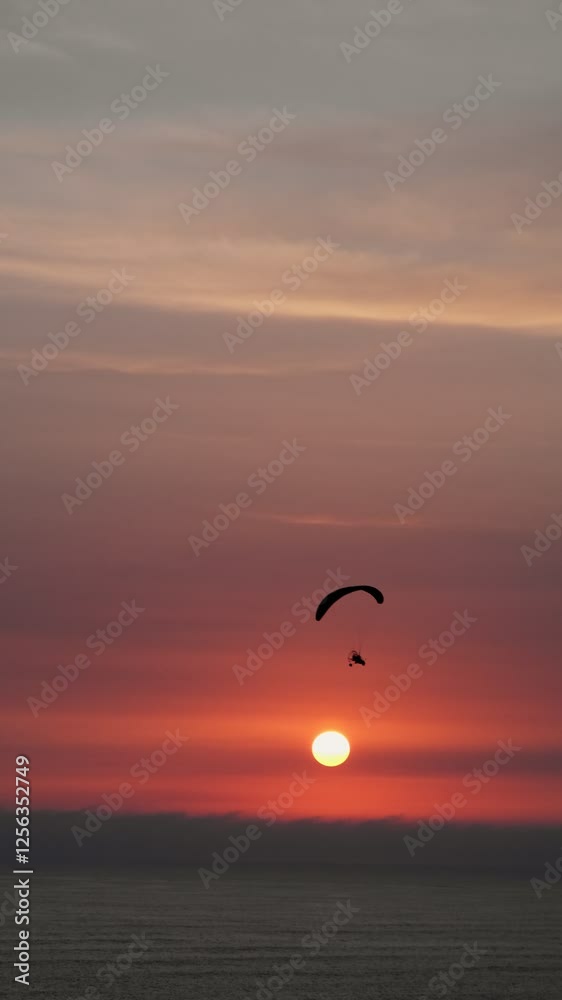 Aerial drone point of view paraglider parachuting over sunny, idyllic rural landscape Aerial drone point of view paraglider parachuting over sunny, idyllic rural landscape