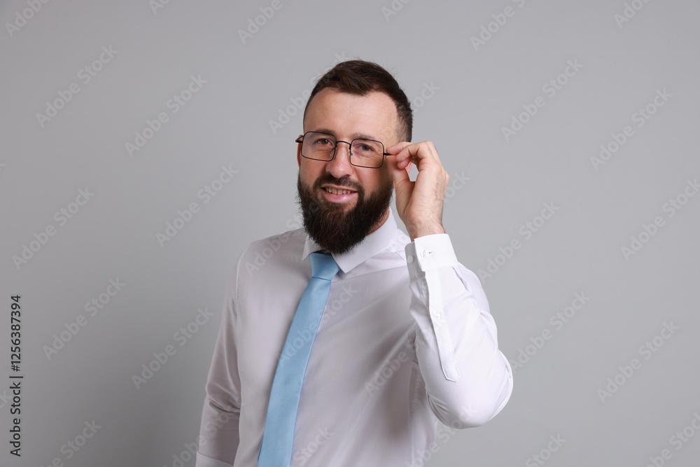 Handsome bearded man in formal outfit on grey background Handsome bearded man in formal outfit on grey background