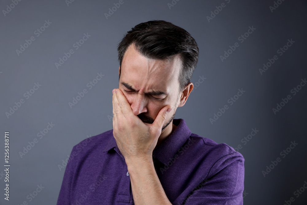 Portrait of sad man crying on grey background Portrait of sad man crying on grey background