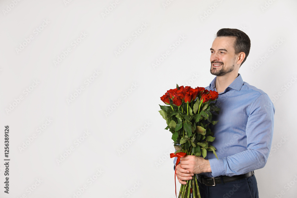 Happy Valentine's Day. Handsome man with bouquet of roses on white background. Space for text Happy Valentine's Day. Handsome man with bouquet of roses on white background. Space for text