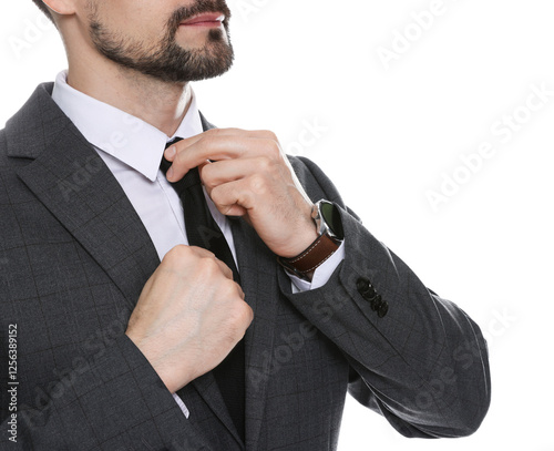 Man in classic suit straightening tie on white background, closeup
