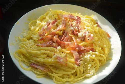 Spaghetti alla carbonara, uovo, pancetta, pepe, noce moscata, pecorino e parmigiano photo