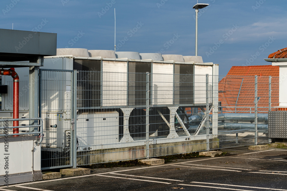 Rooftop cooling system with safety fencing during daylight Rooftop cooling system with safety fencing during daylight