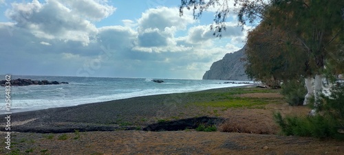 
empty kamari beach based on santorini greece
