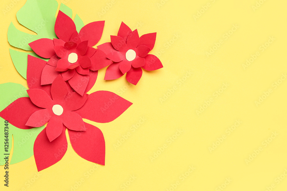 Red origami flowers with leaves on yellow background Red origami flowers with leaves on yellow background