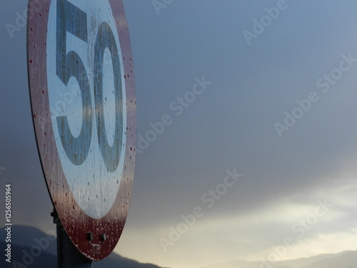 Close-up of a fifty kilometer per hour (kmh) speed limit sign on a road along the fjords in Norway photo