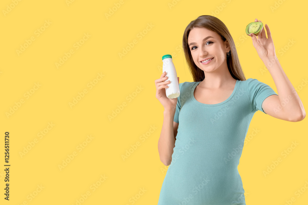 Young pregnant woman with bottle of tasty yoghurt and kiwi on yellow background Young pregnant woman with bottle of tasty yoghurt and kiwi on yellow background
