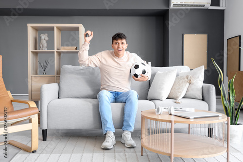 Young man watching football...