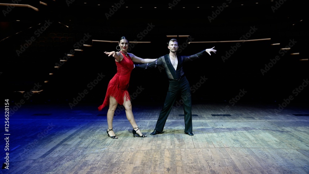 Fototapeta premium Ballroom dancers performing rumba routine on stage