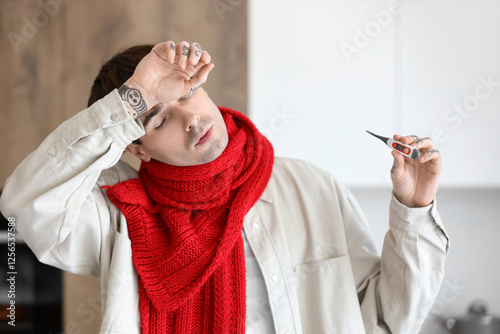 Ill young man with scarf an...