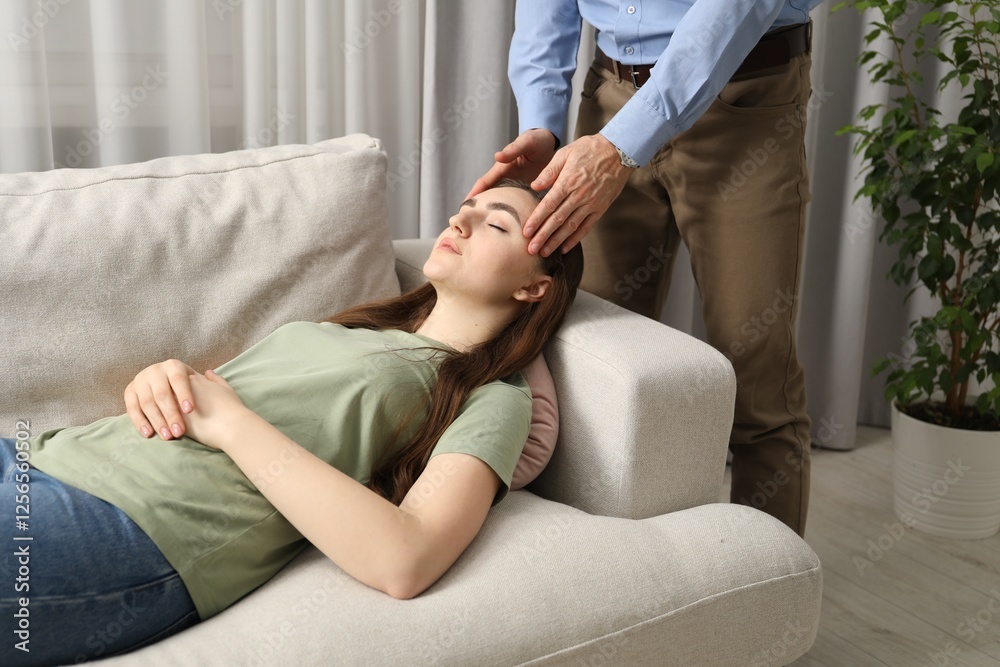 Fototapeta premium Psychologist working with patient during hypnosis session indoors, closeup