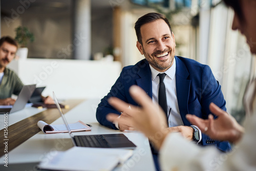 Smiling Professional Colleague In Office Environment During Collaborative Discussion