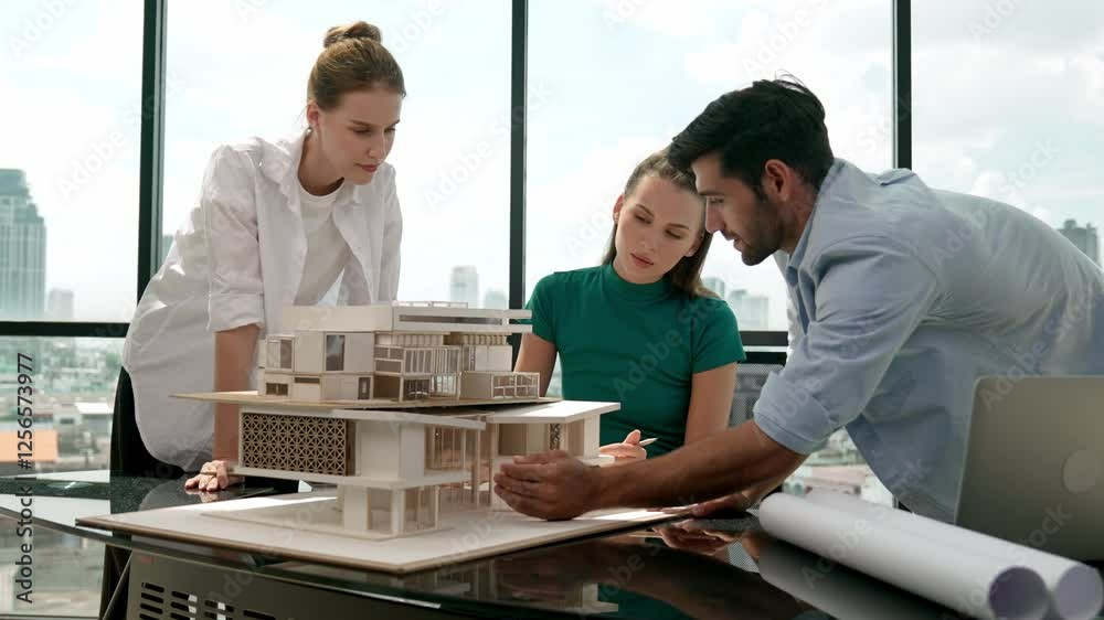 Architect engineer team working together to analyze house model construction while caucasian project manager using laptop analysis data. Group of designer talking about house design. Tracery Architect engineer team working together to analyze house model construction while caucasian project manager using laptop analysis data. Group of designer talking about house design. Tracery