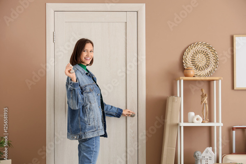 Young woman with key openin...