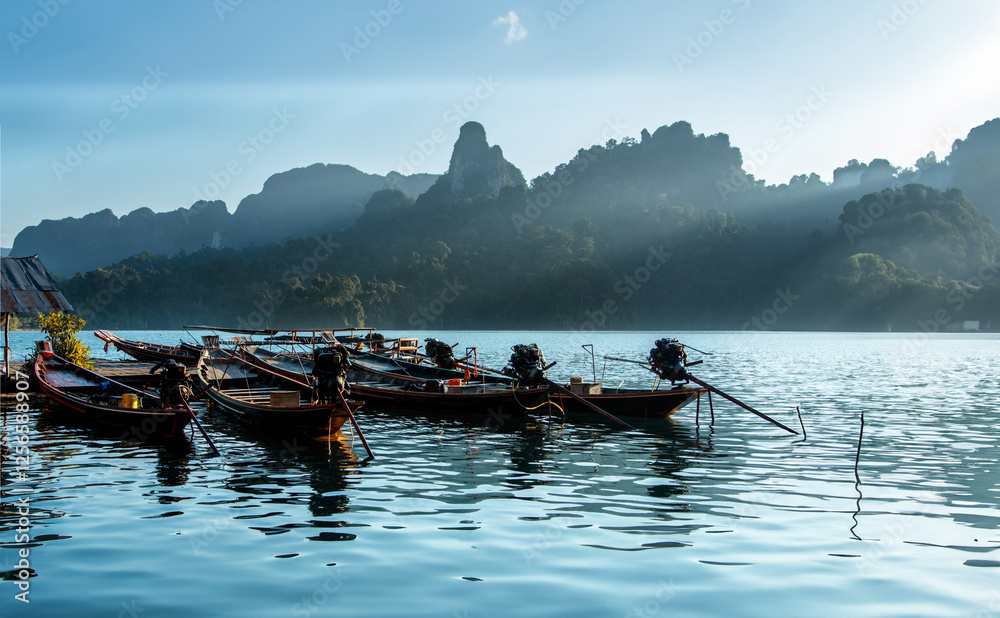 Naklejka premium Thailand's gorgeous boats on its lakes and rivers, surrounded by beautiful scenery
