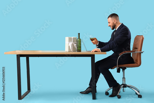 Young man with laptop sitti...