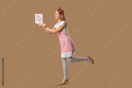 Young pin-up woman with GRL PWR sign on beige background. Women's History Month photo