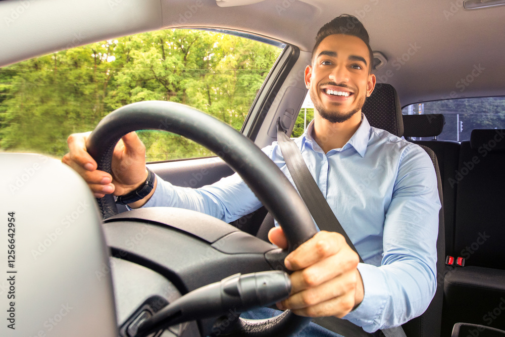Smiling arab guy going to office in the morning, driving his car, copy space, shot from dashboard. Cheerful middle-eastern young man looking at the road, sitting inside luxury automobile, going home Smiling arab guy going to office in the morning, driving his car, copy space, shot from dashboard. Cheerful middle-eastern young man looking at the road, sitting inside luxury automobile, going home