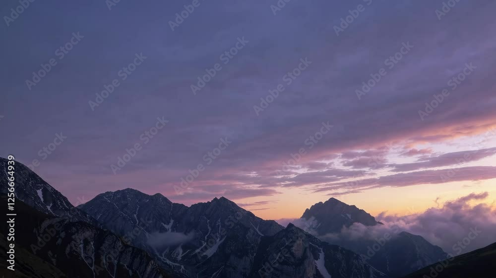 Majestic mountain range at sunset with dramatic clouds, serene nature and tranquility concept Majestic mountain range at sunset with dramatic clouds, serene nature and tranquility concept