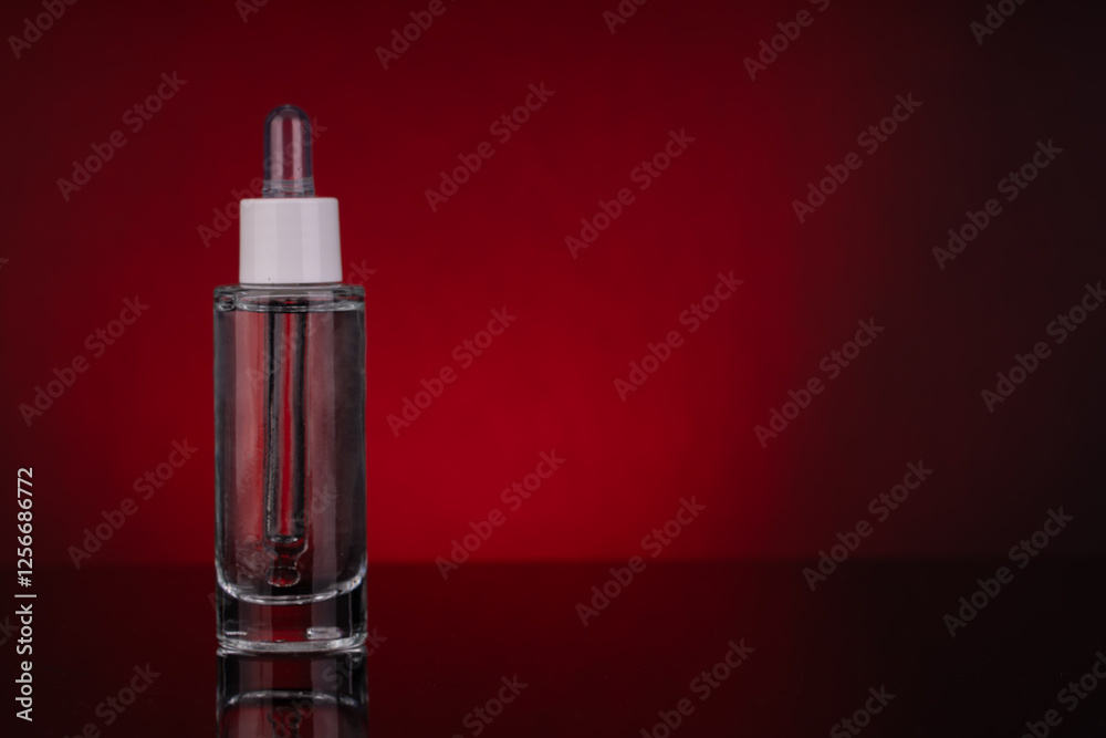 Glass Dropper Bottle with Empty Space for Text on Red Background Glass Dropper Bottle with Empty Space for Text on Red Background
