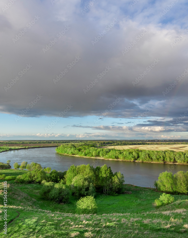 Cloudy sky with a river in the background Cloudy sky with a river in the background