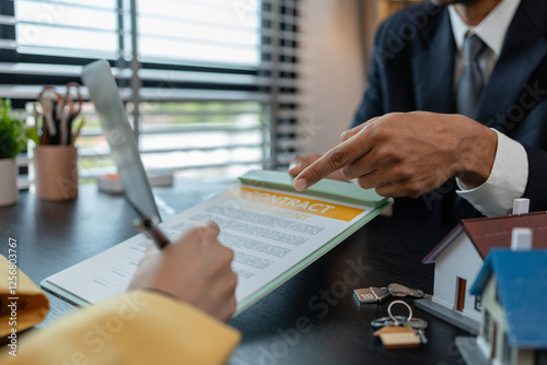 a real estate agent is explaining the details of a home purchase contract to a buyer, he is telling them that is is a worthwhile investment, property, estate, mortgage