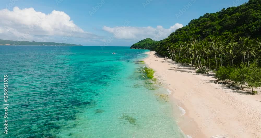 Tourist boat floating over clear water in Puka Shell Beach. Boracay Island. Philippines.