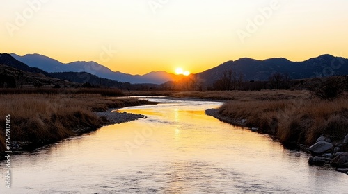 Serene sunset over a winding river with mountains in the background, tranquil nature scene