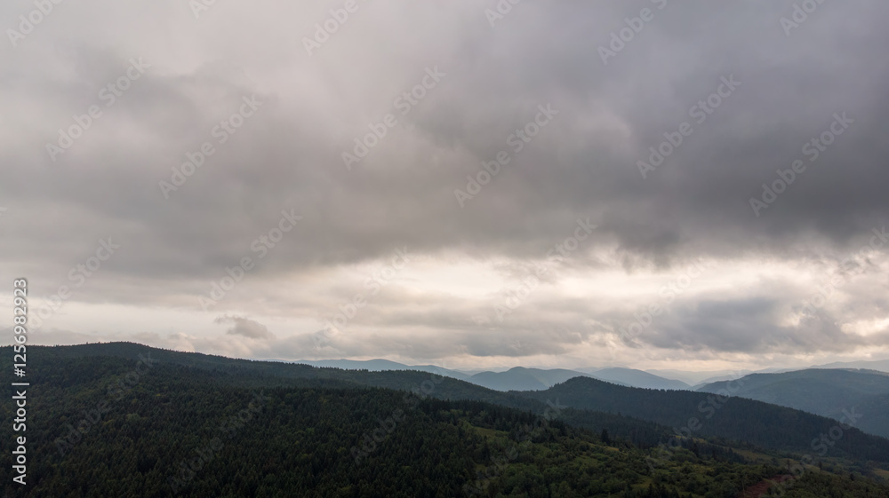 Magnificent Aerial View Of Mountains And Dense Forests Under Dark Clouds, With Raindrops Falling, Creating A Dramatic And Serene Atmosphere In A Remote Natural Landscape. Magnificent Aerial View Of Mountains And Dense Forests Under Dark Clouds, With Raindrops Falling, Creating A Dramatic And Serene Atmosphere In A Remote Natural Landscape.
