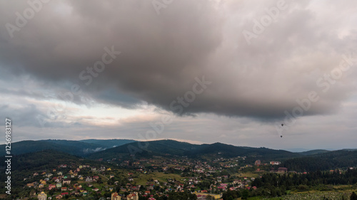 Majestic Mountains, Dense Forest, And Dramatic Clouds Illuminated By A Stunning Sunset. Aerial View Capturing The Breathtaking Beauty Of Nature From A Bird’s-Eye Perspective.