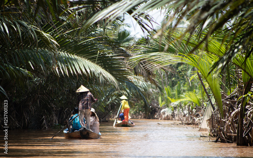 Tablou pe pânză Sampan boats cruising the waterways of the Mekong Delta in Vietnam