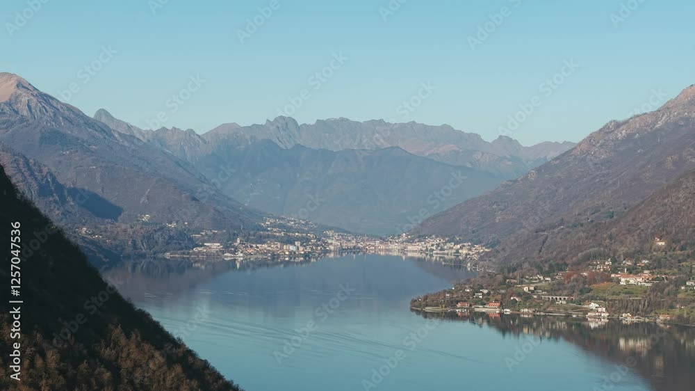 A stunning aerial view of Lake Orta, nestled in an autumnal Italian landscape, showcasing tranquil waters, picturesque villages, and mountainous background scenery under a clear sky. A stunning aerial view of Lake Orta, nestled in an autumnal Italian landscape, showcasing tranquil waters, picturesque villages, and mountainous background scenery under a clear sky.