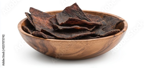 A rustic presentation of homemade beef jerky slices, beautifully seasoned with a blend of spices and herbs, served in a warm-toned wooden bowl that highlights its rich, hearty texture and flavors photo