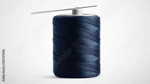 Dark blue sewing thread spool, isolated on white background. Possible use for sewing craft projects photo