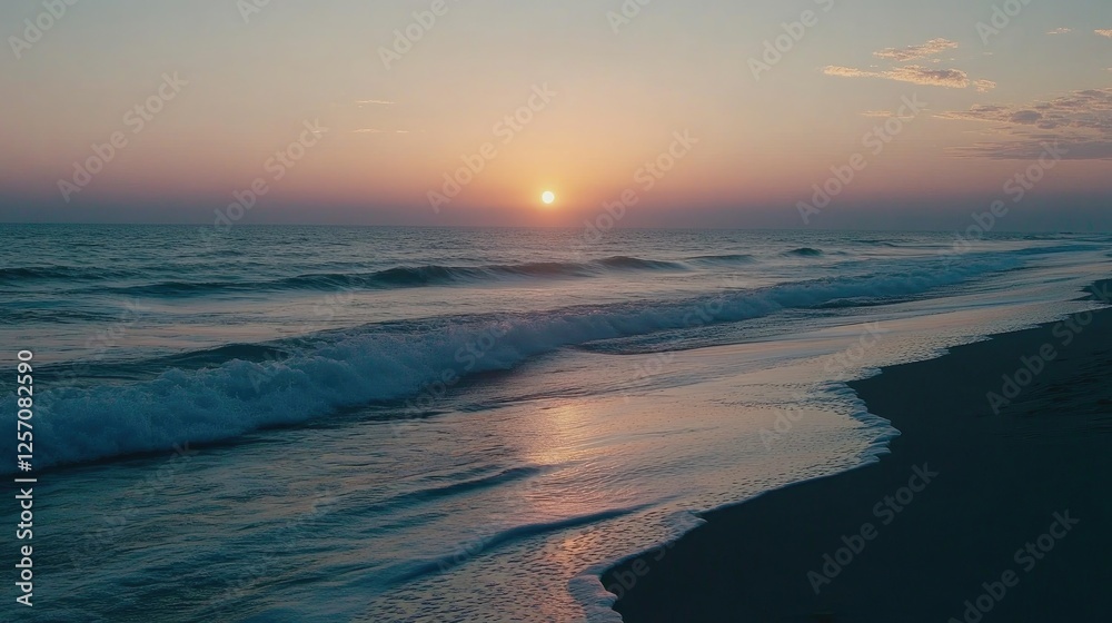 Fototapeta premium A beachside sunrise with pastel-colored skies reflecting on the gentle waves.