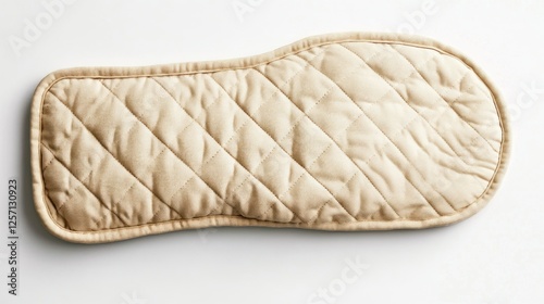 Beige quilted oven mitt on white background photo